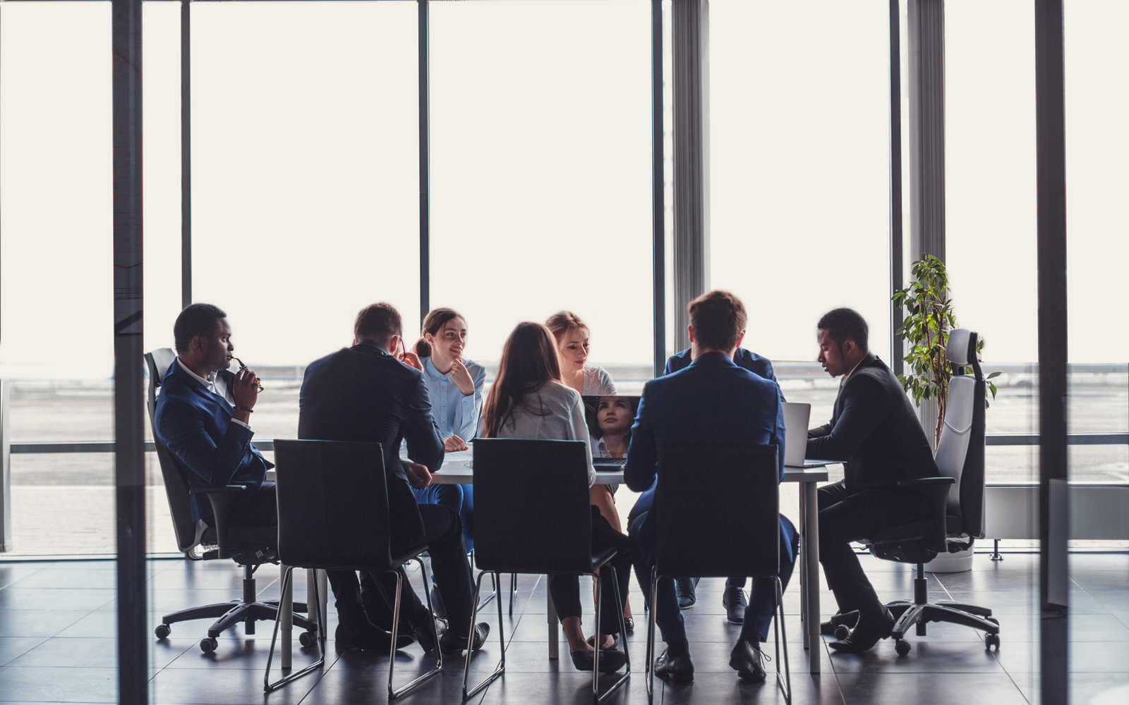 Executive peer group meeting around a boardroom table
